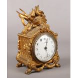 A gilt metal eight day mantel clock, surmounted with nesting birds. 20cm tall.