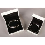 Two silver Pandora bracelets in original box.