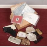 A box of linen and ladies purses.