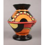 A Lorna Bailey pottery vase in the flapper design. H: 19cm. Signed to the base. Condition good. No