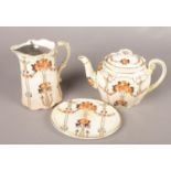 Three pieces of Keeling & Co ceramics by Kensington. To include teapot, jug and standing plate.