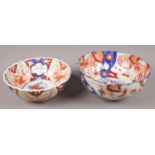 Two Japanese Imari bowls. Both with central floral design. One with chip and crack to rim.