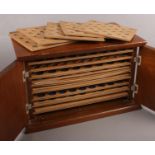A wooden coin cabinet with contents of a good quantity of mainly British pre decimal coins. Includes