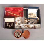 A box of assorted cuff links, tie pins and studs, etc.