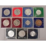 A collection of cased world coins. Includes Dollars, Thaler, Apollo 11 moon landing etc.