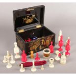 A Chinoiserie lacquered box with contents of mostly Cantonese ivory chess pieces, etc.