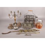A quantity of assorted metalwares. To include a copper kettle, two candle sticks with snuffs ,fire