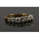 An 18ct gold and diamond seven stone ring. (1ct of diamonds). Size R 1/2. 3.67g.