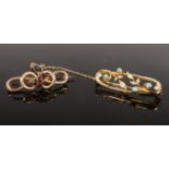 Two 9ct gold brooches. One set with garnets and the other with pearls. Gross weight 6.57g.