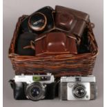 A Wicker Basket containing Eight Cameras, Five of which are Film. Examples include Petri 7 S and
