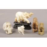 A small group of carved figures. Includes horn skull, soapstone monkeys and ivory.