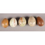 A group of five onyx/wood eggs.