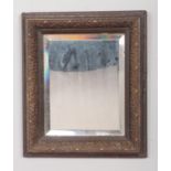 A Small Bevel Edged Mirror with Leaf Patterned Frame. Size of Mirror: H: 25cm, W: 20cm.