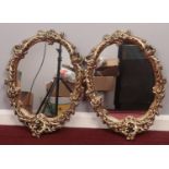 A pair of matching gilt mirrors decorated with flowers and leaves. H: 61cm, W: 45cm. Condition good.