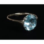 A 9ct gold ring with light blue coloured stone. Size P, Gross weight 1.55g.