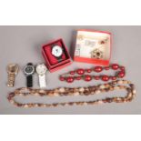 An assortment of costume jewellery. To include brooches, watches and jewellery.