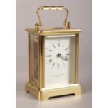A Taylor & Bligh of London brass carriage clock. Comprising of an enamel dial with Roman and