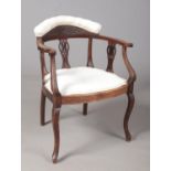 A Victorian mahogany salon chair. With carved and pierced decoration.