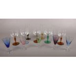 A group of coloured glasses. To include five coloured Sherry glasses and five coloured stem