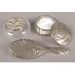 A ladies art nouveau style pewter vanity set. To include a pewter brush and powder puff dish,