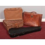 A group of four cases. To include an empty picnic basket, violin case, suitcase & leather briefcase.