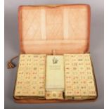 A Complete Mahjong Set, with Counters and Dice in a Faux Snakeskin Case.