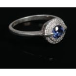 A white metal diamond & blue stone cluster ring. Size O.