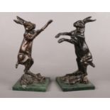 A pair of cast metal book ends depicting fighting hares. H:26cm.