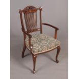 An Edwardian inlaid mahogany comb back arm chair.