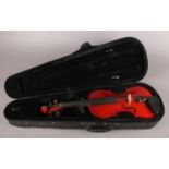 A cased Marcato violin.