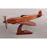 A wooden model spitfire. (19cm height 42cm width)