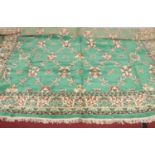 A large emerald green ground Belgium rug. L: 337cm, W:258cm.