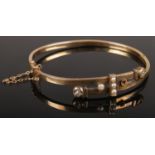 A 15ct gold diamond and pearl bangle. 9.38g.