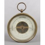 A vintage circular aneroid barometer. Crack to glass.