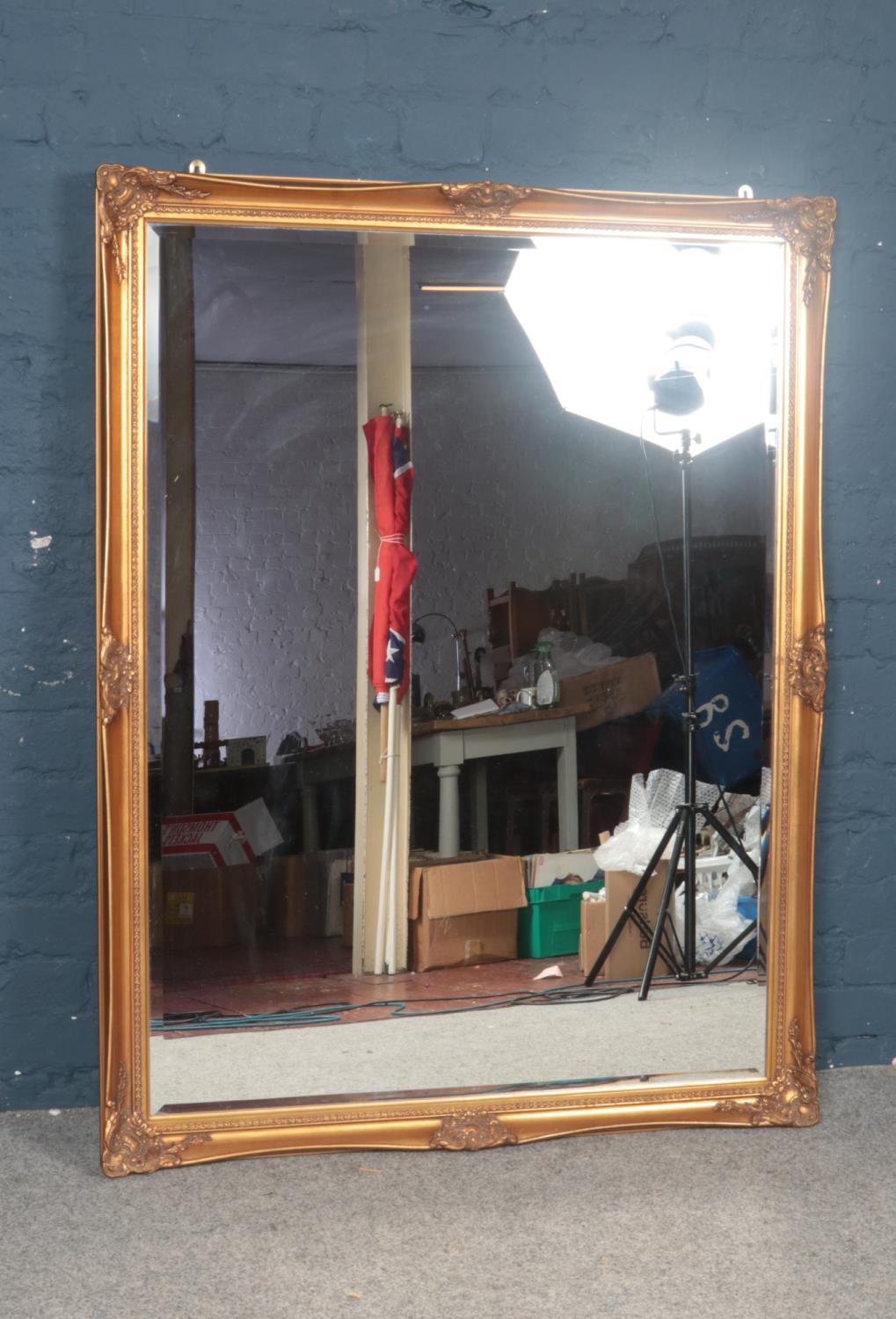A large gilt framed bevelled mirror. 103 x 136 cm.