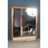 A large gilt framed bevelled mirror. 103 x 136 cm.