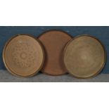Three large brass circular trays/table tops. Largest 62cm diameter.