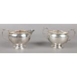 A Silver cream jug and sugar bowl. Both items were assayed in Birmingham 1936 by Israel Sigmund