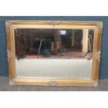 A large framed bevelled edged mirror with gilt frame. H:62cm, W:88cm.