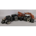 A group of eight vintage cameras and cases. To include Kodak Brownie Model 1, Brownie C six -20,