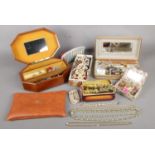 A quantity of costume jewellery and a small musical box. To include necklaces, watches earrings,