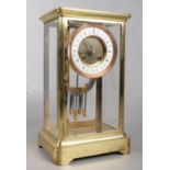A brass and glass Japy Freres mantel clock. With Roman numeral markers, chiming on a coiled gong,