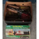 A box of tools. Including ceramic tile cutter, hammers, screwdrivers, etc.