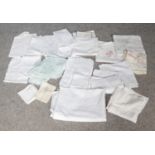 A group of vintage linens. To include tablecloths and napkins. Some are embroidered with flowers and