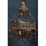 A large Eastern brass chandelier. With multiple colour light bulbs and bead decoration.