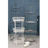 A collection of garden items. Includes folding shelving units, metal planter stand and a concrete