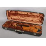 A cased violin. Spurious Stradivarius label.