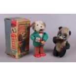 Two mechanical clock work toys. Including boxed The Greedy Pup example, etc.