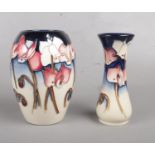 Two Moorcroft vases. By Emma Bossoms. 14.5cm & 13cm height.