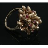 A 9ct Gold Ring (Size M) with Six Small Rubies mounted on a Large Decorative Bridge.